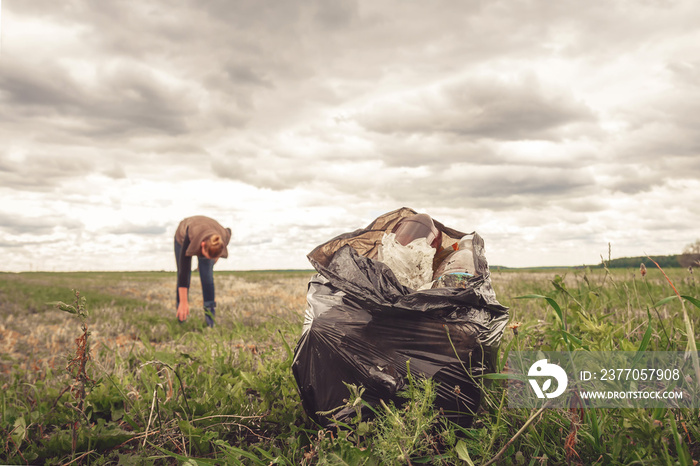 Recycle waste litter rubbish garbage trash junk clean training. Nature cleaning, volunteer ecology green concept. Young woman pick up spring forest at sunset . Environment plastic pollution