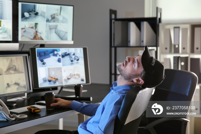 Security guard sleeping in surveillance room