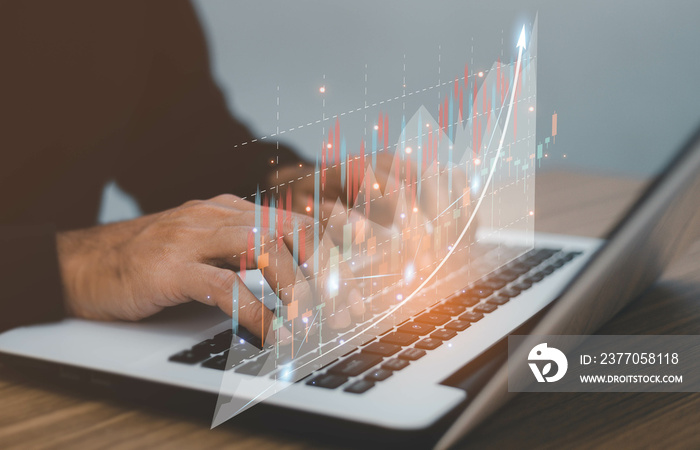 Male trader investor analyst holding smartphone in hand analyzing stock market trading charts indexes data checking price using mobile stockmarket exchange app.