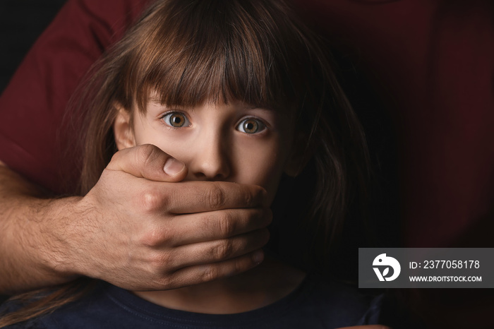 Father covering mouth of his scared little daughter, closeup. Concept of domestic violence