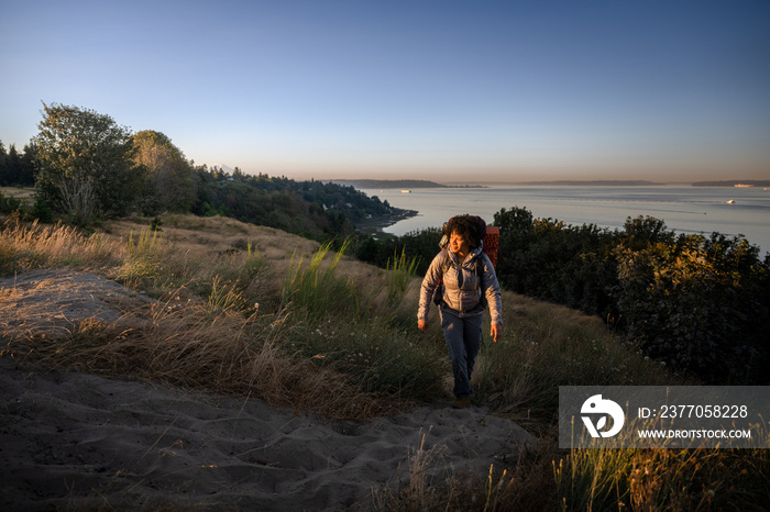 U.S. Army female soldier putting in the miles with an early morning hike in the NorthWest.