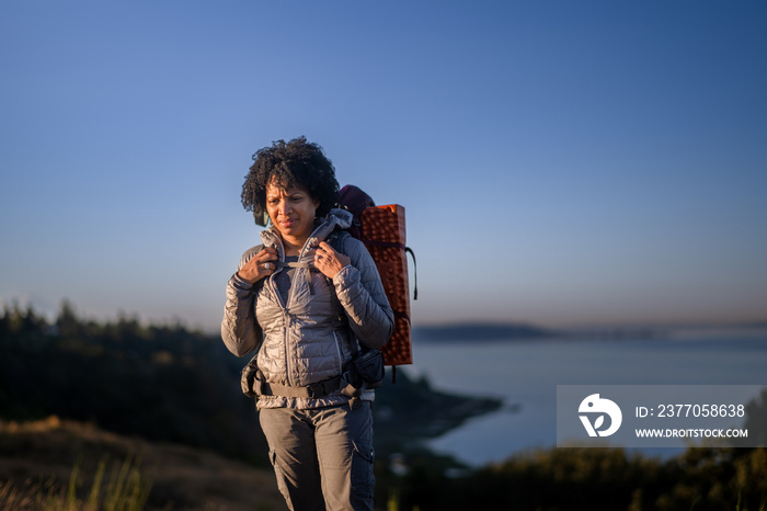 U.S. Army female soldier putting in the miles with an early morning hike in the NorthWest.