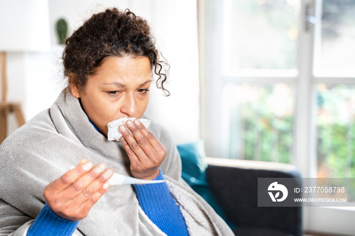 Portrait of black woman suffering cold and flu at home