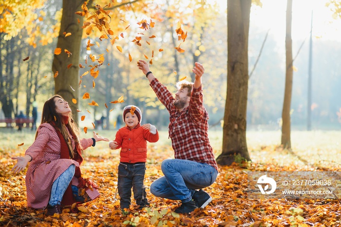 happy young family spending time outdoor in the autumn park