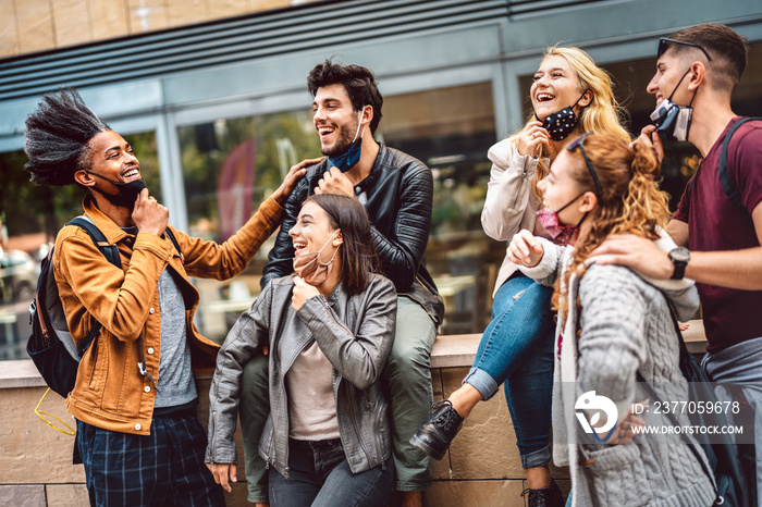 Multicultural friends having fun at city center - Happy guys and girls sharing time together at urban area - University students on spring vacation after lockdown reopening - Warm contrast filter