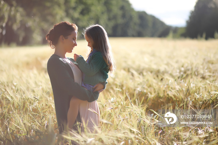 A young mother walk in wheat fields