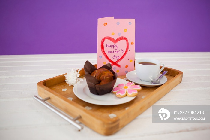 Happy mothers day greeting card with tea and snacks