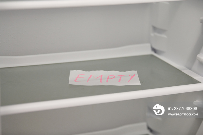 Empty refrigerator concept. Empty shelves of new refrigerator. Weight loss diet concept.