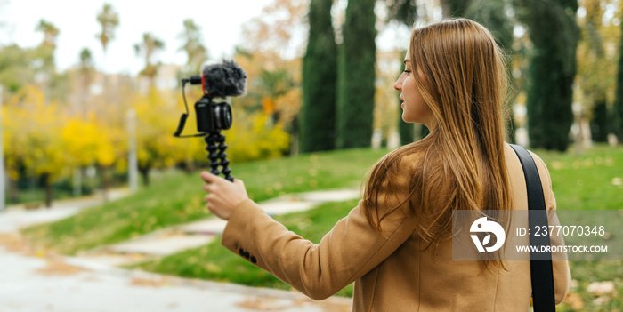 Young stylish woman taking video for vlog. Female vlogger influencer creating social media content