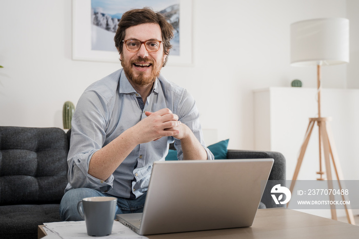 Male businessman working on laptop from home