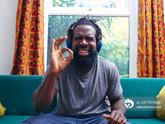 Portrait of man listening to music on headphones