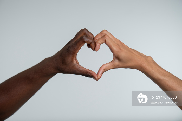 Couple shaping heart with hands