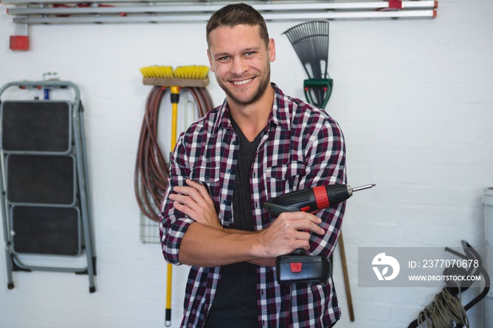 Male carpenter standing with arms crossed