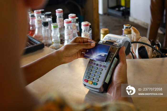 Man paying with card in beach bar