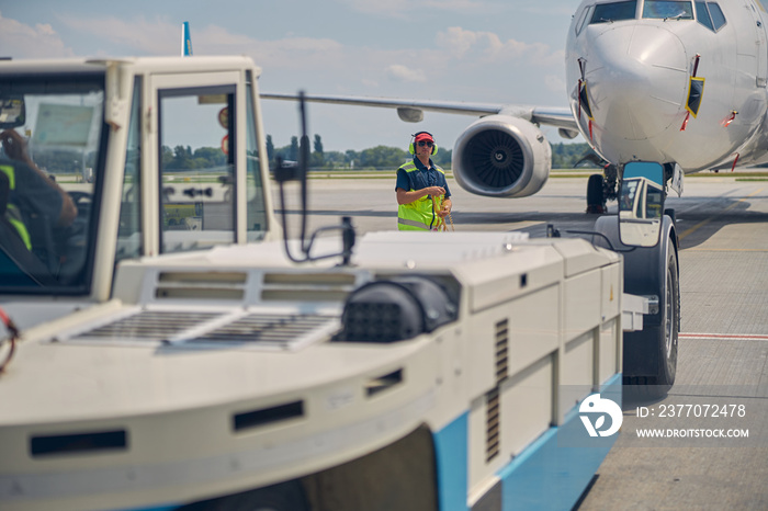 Ground crew preparing for towing an airplane