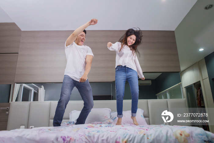 Woman having fun with her husband on a bed