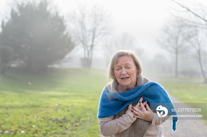 Senior lady clutching her chest in pain