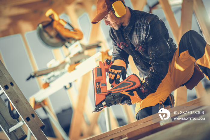 Contractor Working With Wood Using Nail Gun