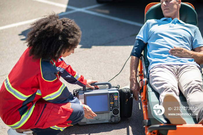 Doctor providing emergency care to an unconscious patient