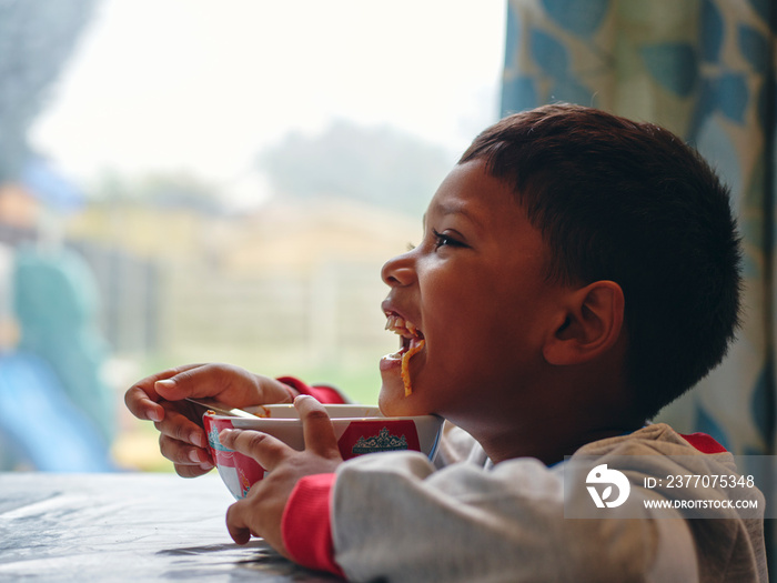 Boy eating from bowl