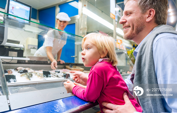 Family at the fish counter in a supermarket