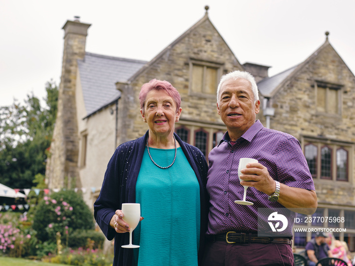 Portrait of senior couple holding wine glasses