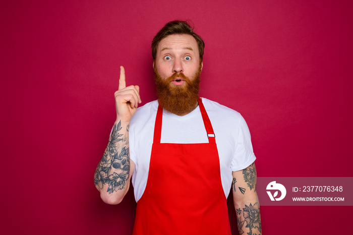 amazed isolated chef with beard and red apron