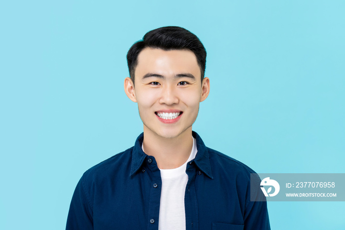 Portrait of  smiling young Asian man in plain casual clothes