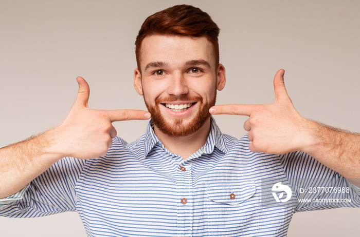 Young millennial man showing his beautiful smile