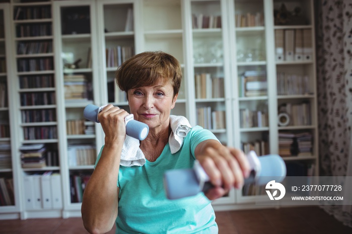 Senior woman exercising with dumbbells