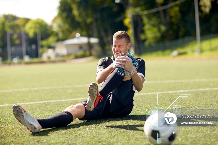 injured soccer player with ball on football field