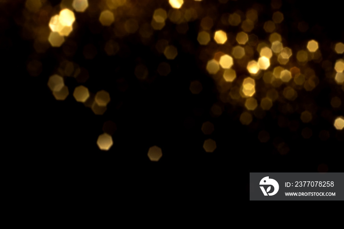 Golden blurred bokeh lights on black background. Glitter sparkle stars for celebrate. Overlay for your design