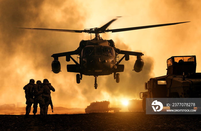 2 soldiers helping wounded soldier between dust in battle field to board the helicopter