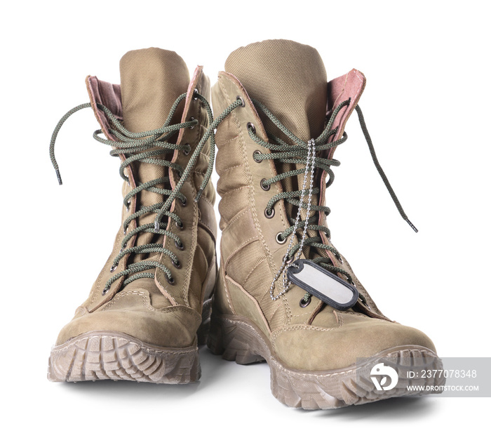 Military boots and dog tag on white background