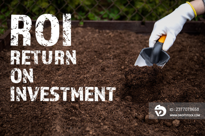 ROI Return on investment. Diging the soil with a garden shovel