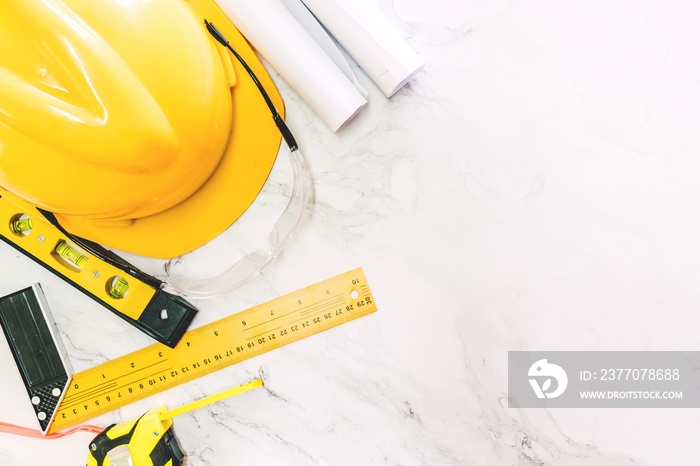 Construction tools with helmet safety on white marble background