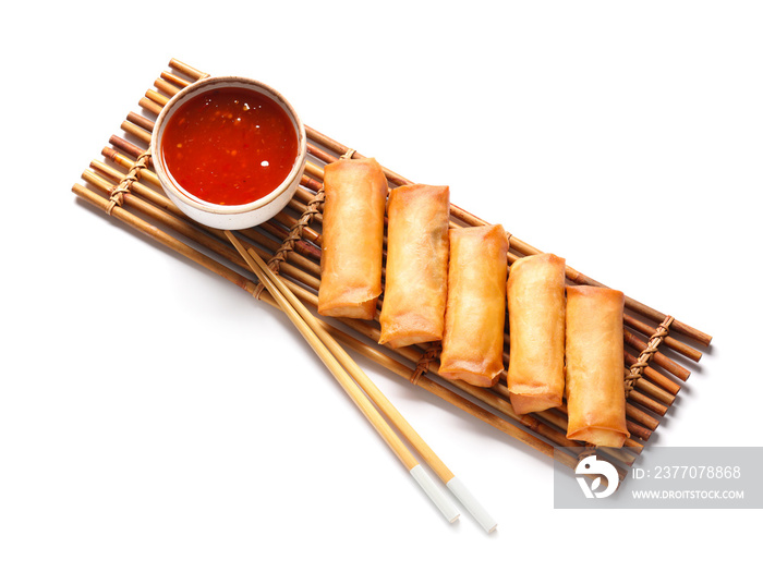 Tasty fried spring rolls and sauce on white background