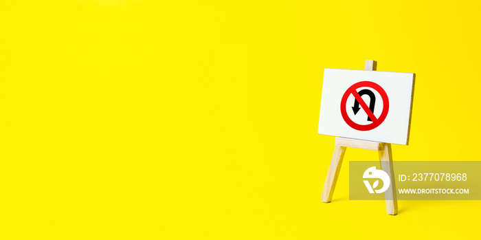 Easel with no turning back traffic sign on a yellow background. Assertiveness and striving, moving forward without retreating. Go to the goal, don’t stop. Finish things. There is no way back.