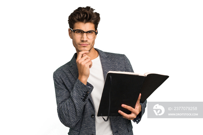 Young teacher caucasian man holding a book isolated