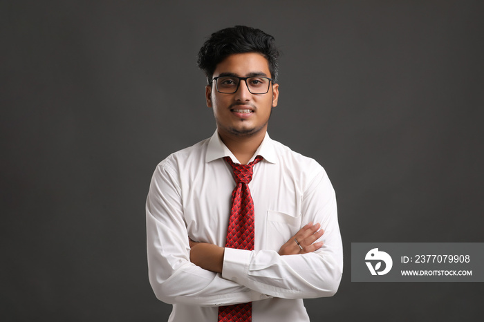 Young indian man showing expression on dark background.