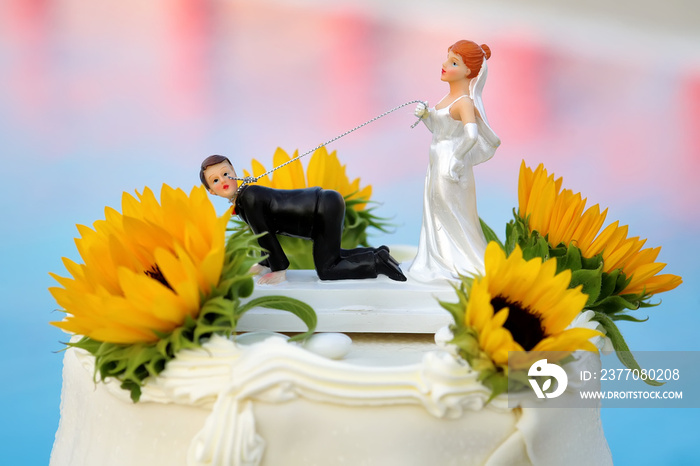 Wedding cake with funny decoration on the background of the pool