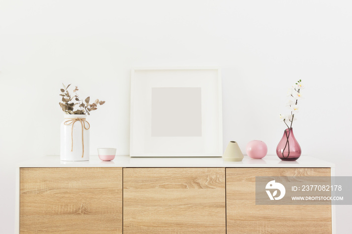 Empty square white frame in living room interior with nordic decoration