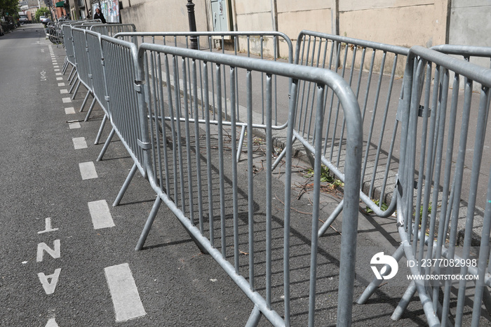 Stack of metal fences in by a street Concept big public event preparation and crowd and safety control.