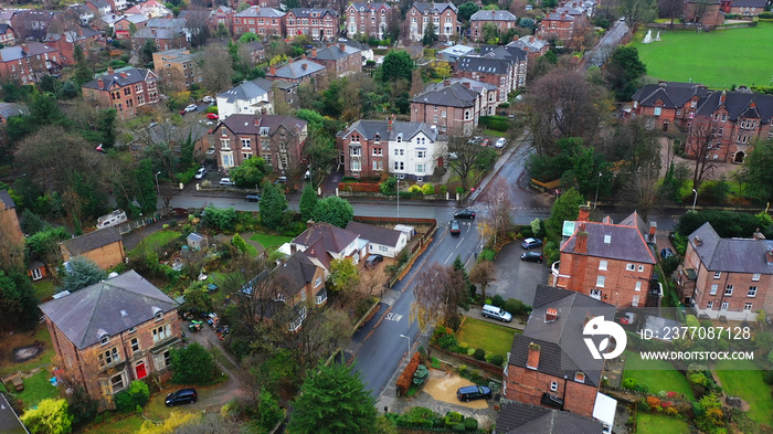 Aerial view over suburban homes and roads in Birkenhead, UK