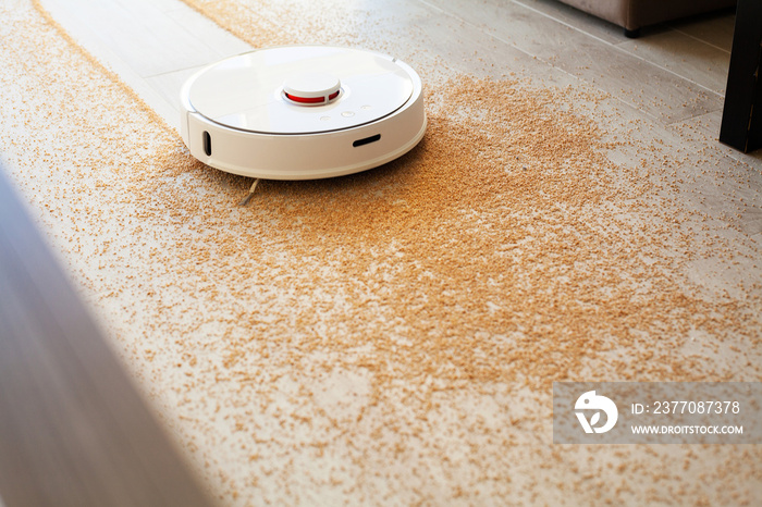 Robot vacuum cleaner performs automatic cleaning of the apartment at a certain time. Smart home.