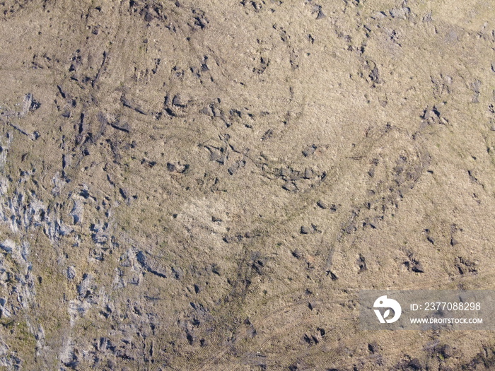 Traces of construction equipment on the soil, aerial view. Lifeless land, wasteland.