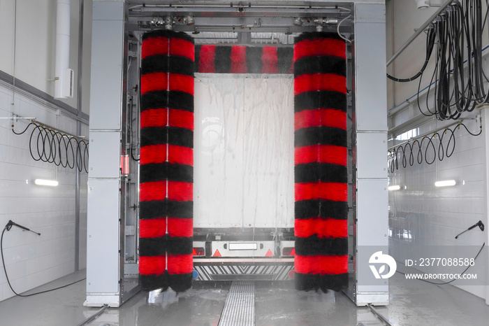 Truck at a car wash using high pressure hot water with detergents. Keeping trucks clean. Service maintenance.