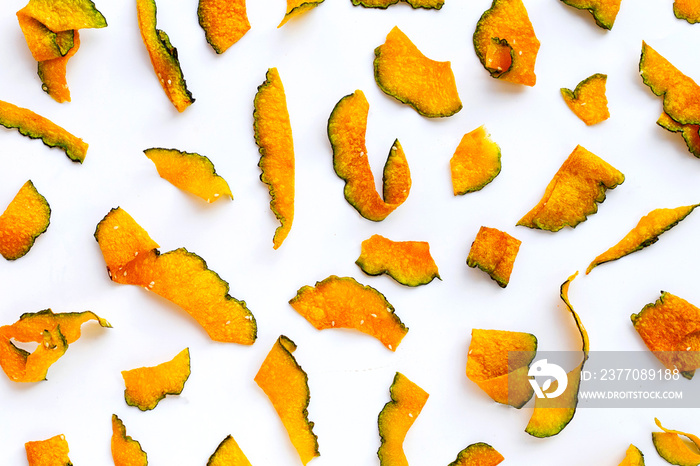 Green pumpkin slice chips on white background.