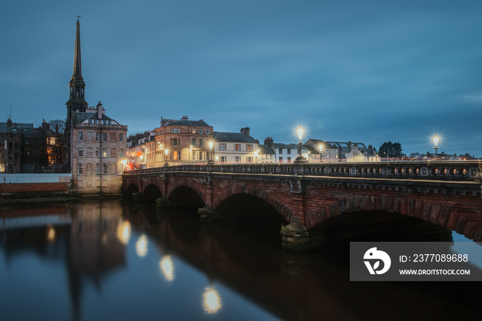 Night view of bridge over the River Ayr and embankment at the Ayr city. Street lamps light. Ayr, Scotland, United Kingdom