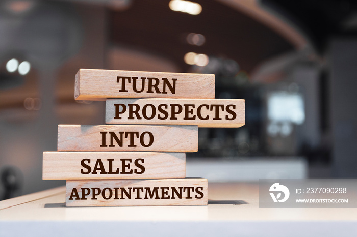 Wooden blocks with words ’Turn Prospects Into Sales Appointments’.